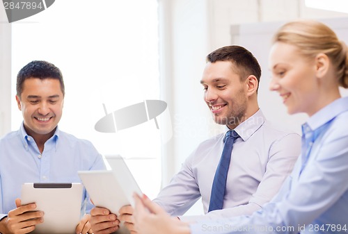 Image of business team working with tablet pc in office