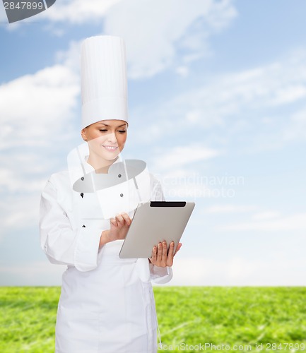 Image of smiling female chef with tablet pc computer