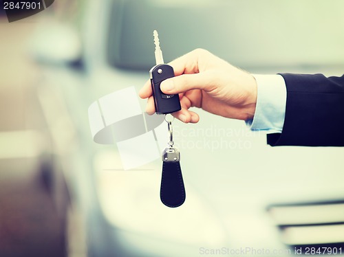 Image of man with car key outside