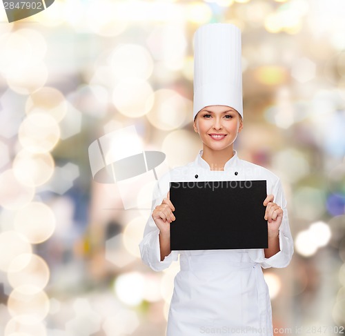 Image of smiling female chef with black blank paper