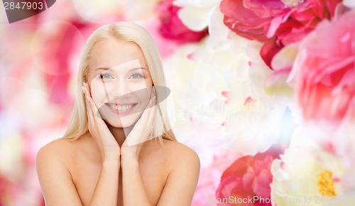 Image of beautiful woman touching her face skin