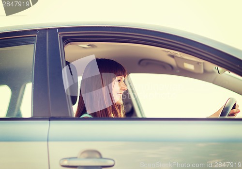 Image of happy woman driving a car