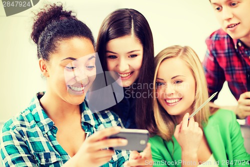 Image of students looking at smartphone at school