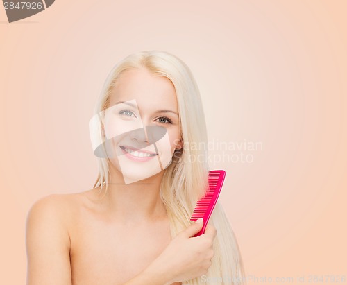 Image of smiling woman with hair brush