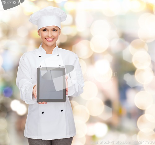 Image of smiling female chef with tablet pc blank screen