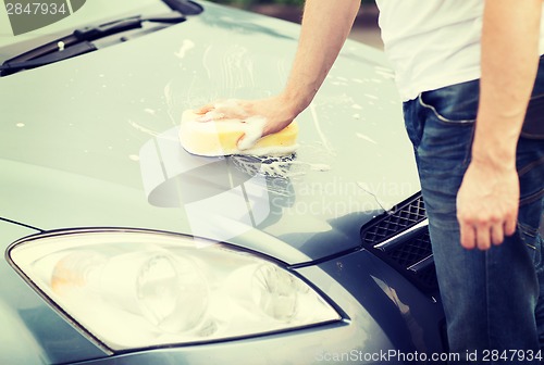 Image of man washing a car