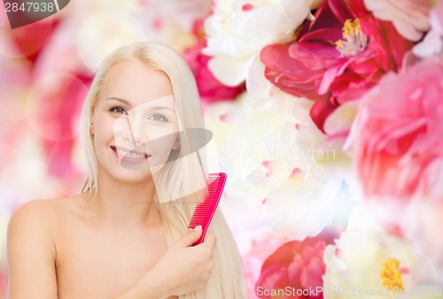 Image of smiling woman with hair brush