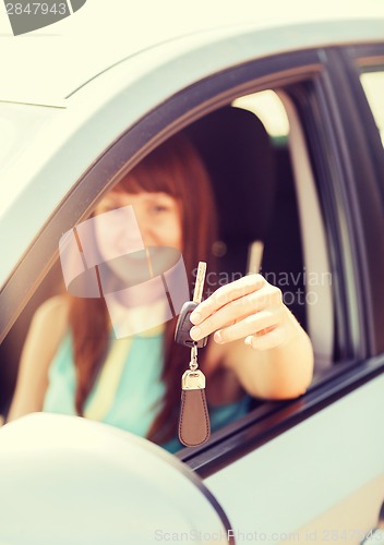 Image of happy woman holding car key