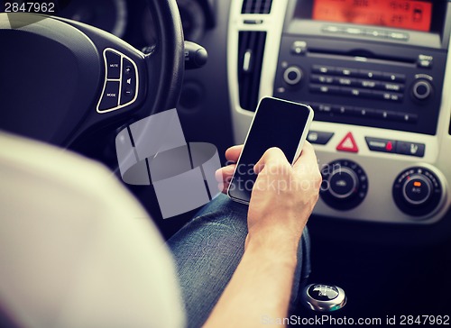 Image of man using phone while driving the car