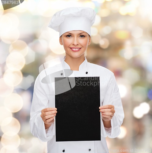 Image of smiling female chef with black blank paper