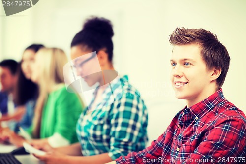 Image of student with computer studying at school