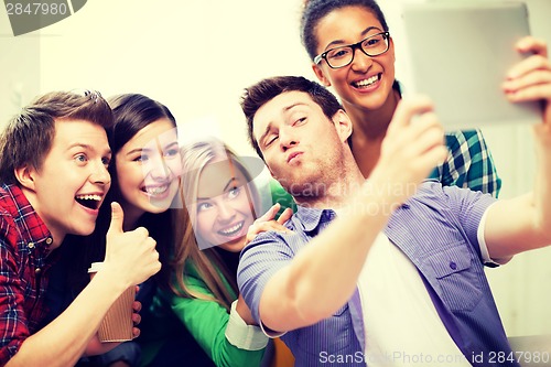 Image of students making picture with tablet pc at school