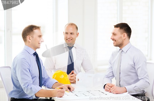 Image of happy team of architects and designers in office