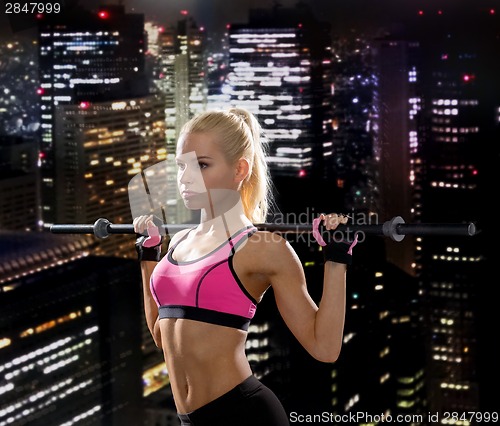 Image of sporty woman exercising with barbell