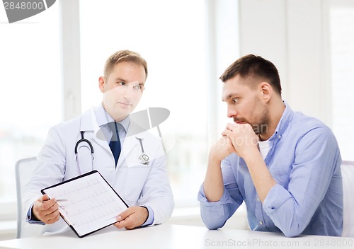 Image of doctor with clipboard and patient in hospital