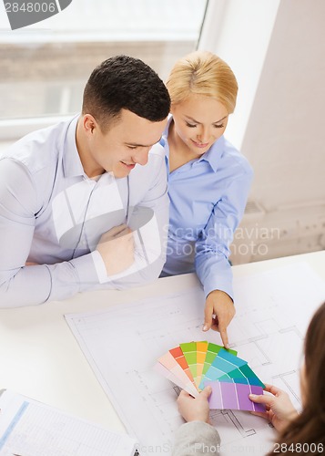 Image of couple looking at blueprint and color samples