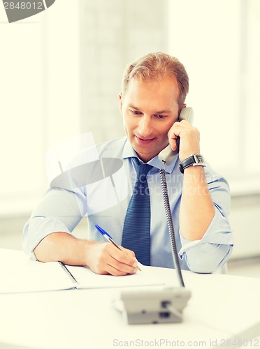 Image of handsome businessman talking on the phone