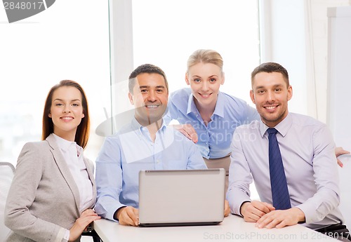 Image of business team working with laptop in office