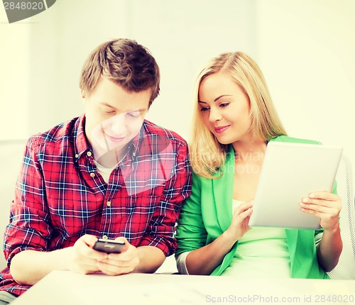 Image of students using smartphone and tablet pc at school