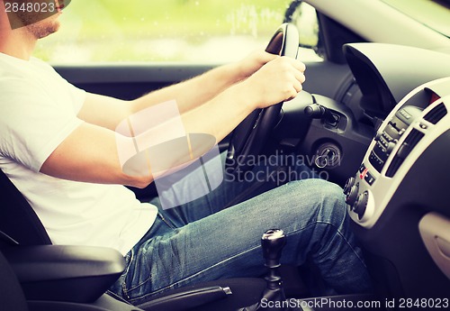 Image of man driving the car with manual gearbox