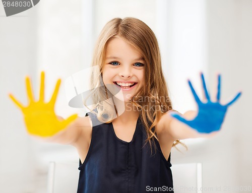 Image of girl showing painted hands