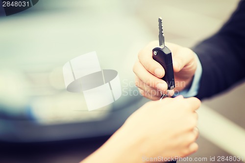 Image of customer and salesman with car key