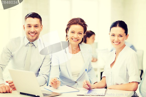 Image of business team discussing something in office