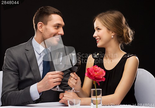Image of young couple with glasses of wine at restaurant