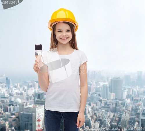 Image of smiling little girl in helmet with paint roller