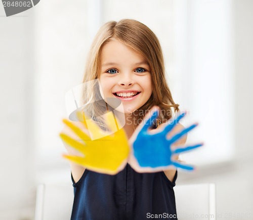 Image of girl showing painted hands