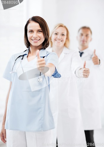 Image of team of doctors showing thumbs up