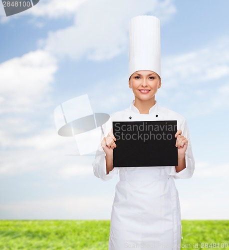 Image of smiling female chef with black blank paper