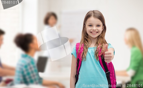 Image of smiling girl with school bag showing thumbs up