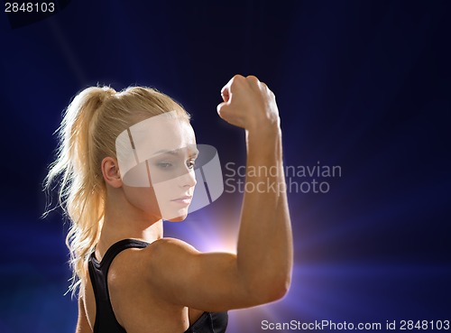Image of close up of athletic woman flexing her biceps