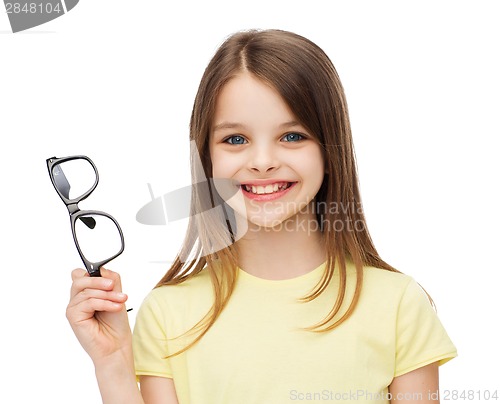Image of smiling cute little girl holding black eyeglasses