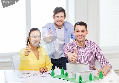 Image of smiling architects working in office