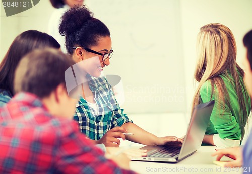 Image of african student girl with laptop at school