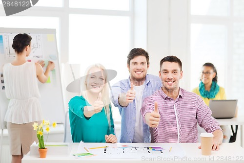 Image of smiling interior designers working in office