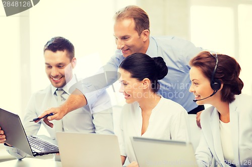 Image of group of people working in call center