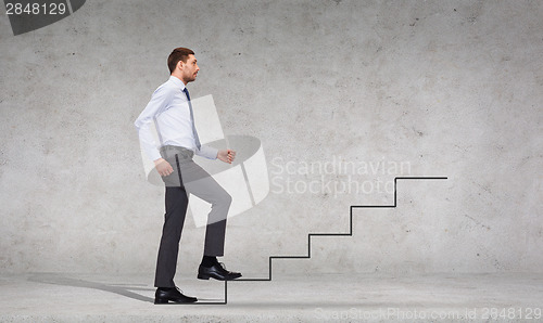 Image of serious businessman stepping on step