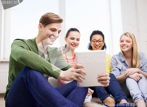 Image of smiling students making picture with tablet pc