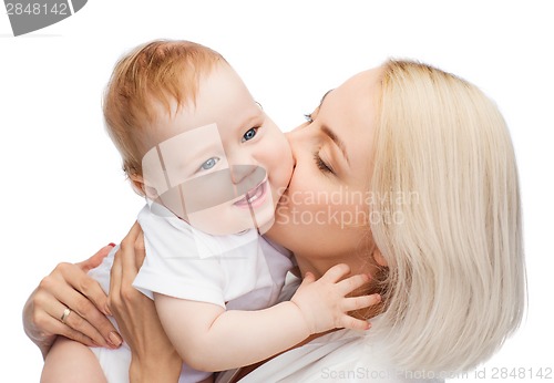 Image of happy mother kissing smiling baby