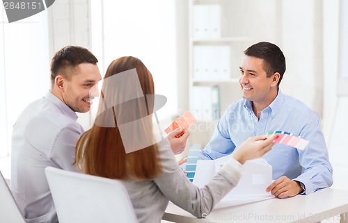 Image of couple looking at model of their house at office