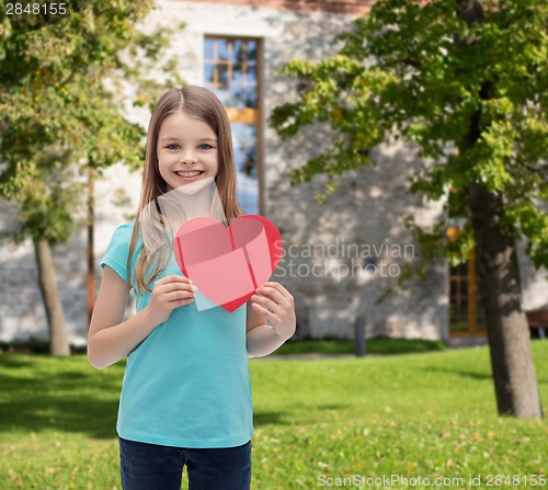 Image of smiling little girl with red heart