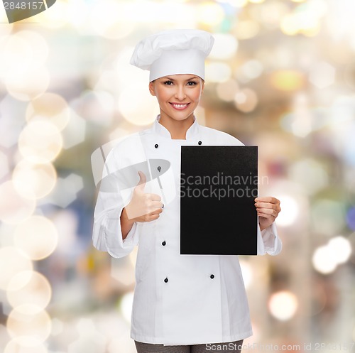 Image of smiling female chef with black blank paper