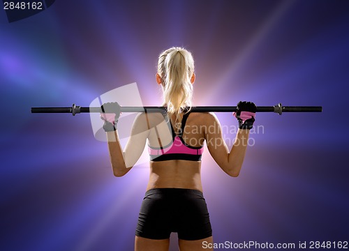 Image of sporty woman exercising with barbell