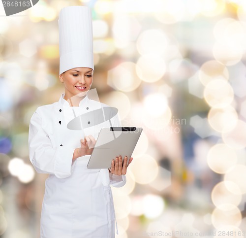 Image of smiling female chef with tablet pc computer