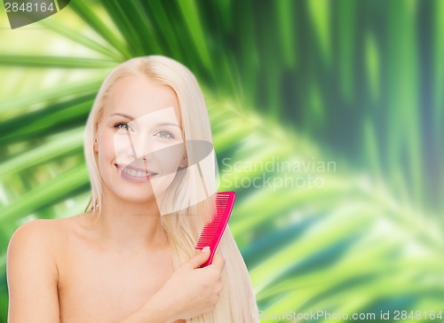 Image of smiling woman with hair brush