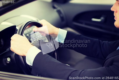 Image of businessman driving a car