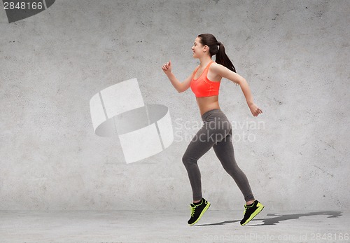 Image of sporty woman running or jumping